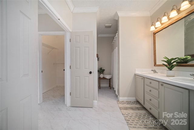 full bathroom featuring ornamental molding, marble finish floor, a sink, and double vanity