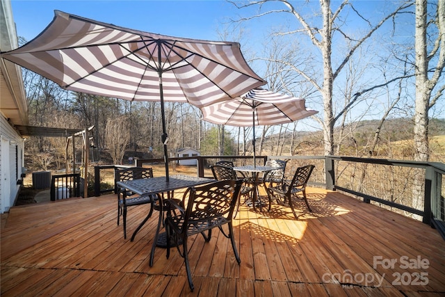 wooden terrace with outdoor dining space