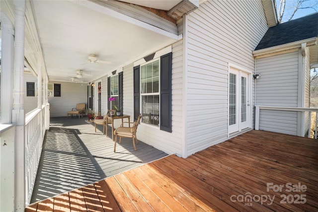 deck featuring covered porch and ceiling fan