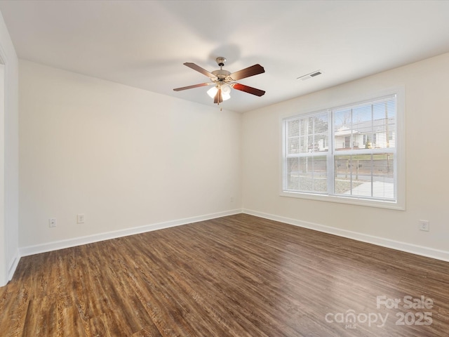 unfurnished room with ceiling fan and dark wood-type flooring