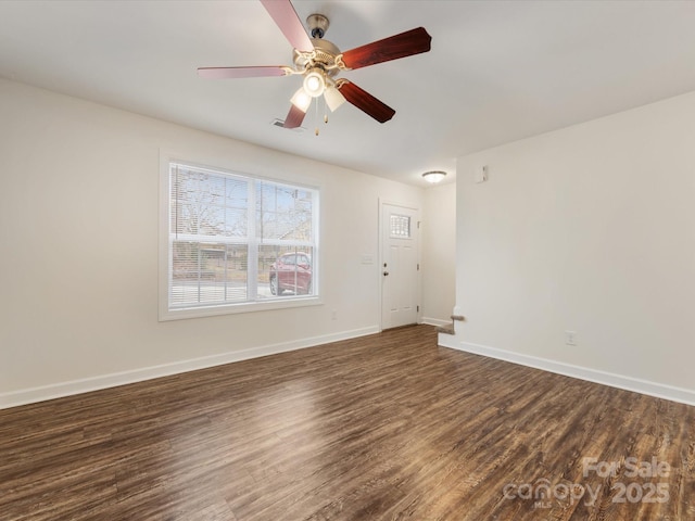 spare room featuring dark hardwood / wood-style flooring and ceiling fan