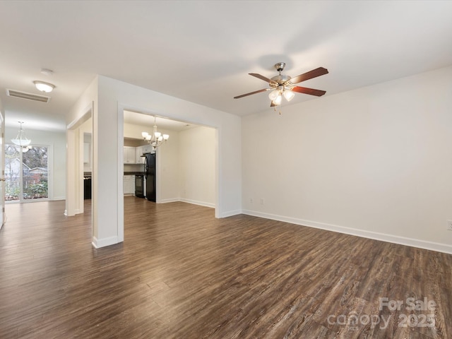 unfurnished living room featuring ceiling fan with notable chandelier and dark hardwood / wood-style floors