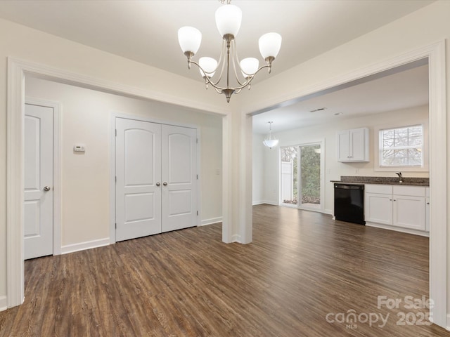 interior space with pendant lighting, black dishwasher, a notable chandelier, dark hardwood / wood-style flooring, and white cabinetry