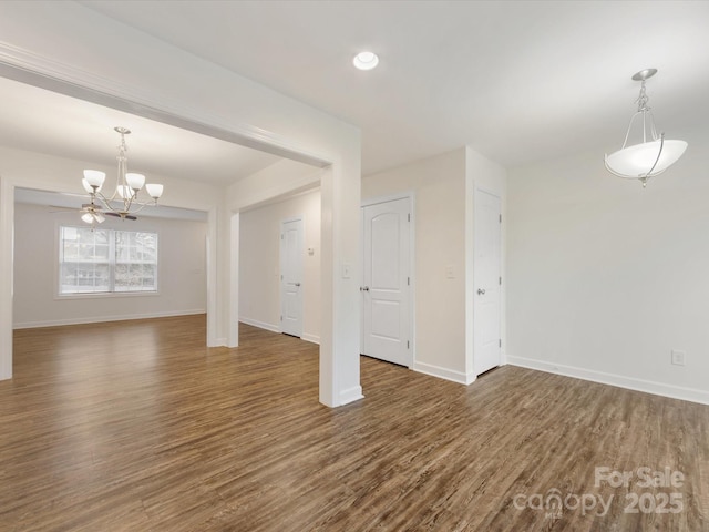 interior space with a chandelier and dark hardwood / wood-style floors