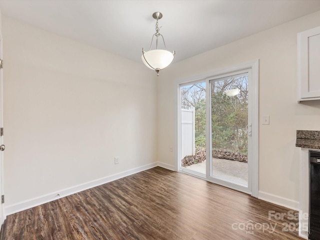 unfurnished dining area featuring dark hardwood / wood-style flooring