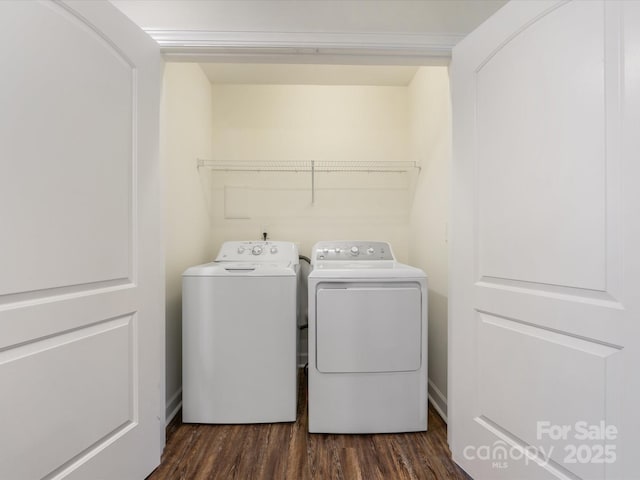 laundry area with dark hardwood / wood-style flooring and washing machine and dryer