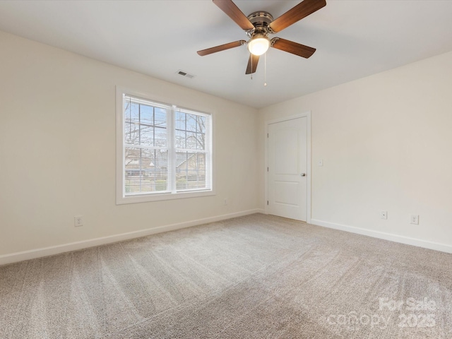 carpeted empty room featuring ceiling fan