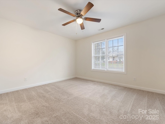 spare room with carpet and ceiling fan