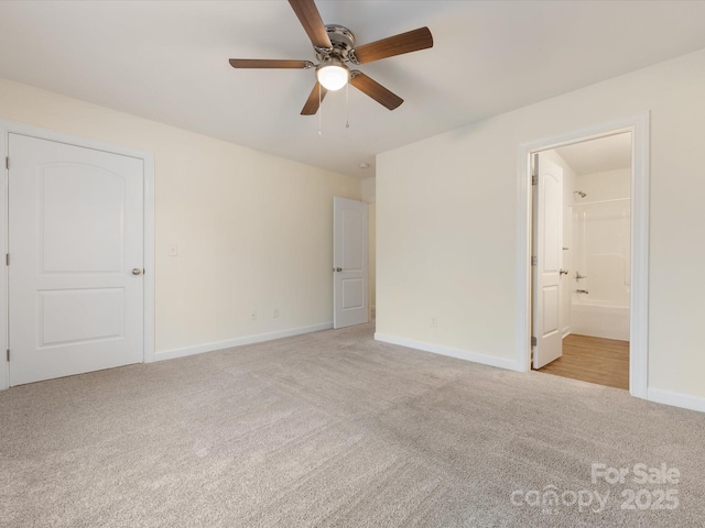 unfurnished bedroom with ceiling fan, light carpet, and connected bathroom