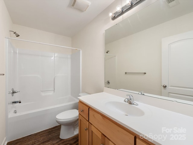 full bathroom featuring hardwood / wood-style floors, vanity, toilet, and tub / shower combination