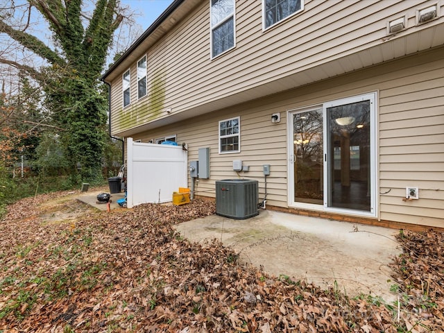 rear view of property with central AC unit