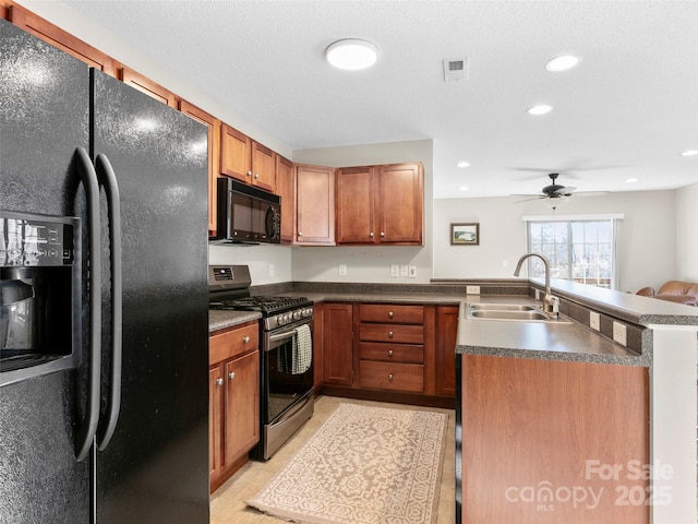 kitchen featuring light tile patterned floors, sink, ceiling fan, and black appliances