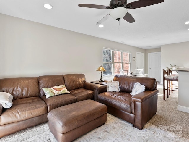 living room with light colored carpet and ceiling fan