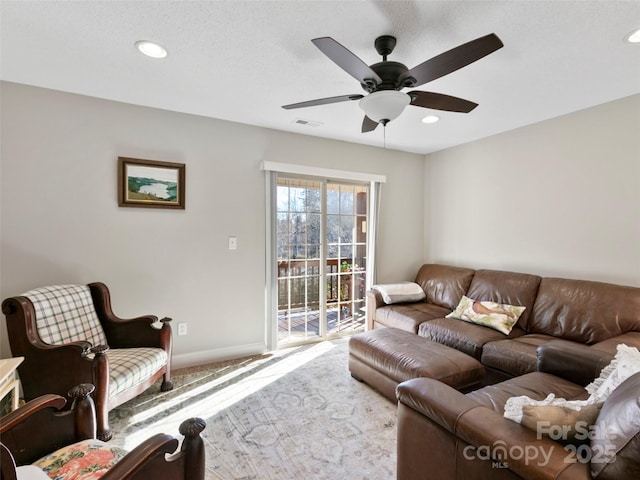 carpeted living room with ceiling fan