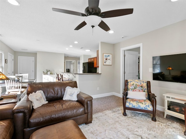 living room featuring light colored carpet and ceiling fan