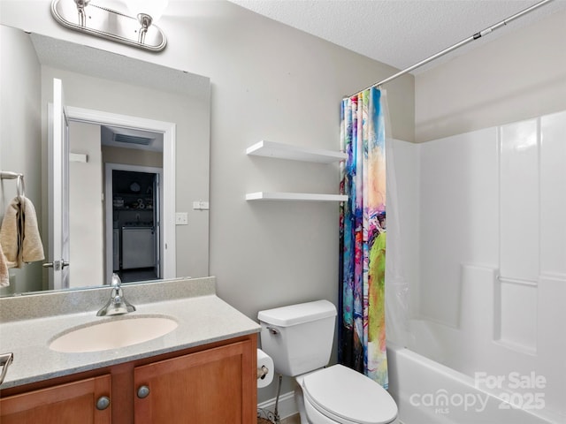 full bathroom featuring vanity, shower / bath combination with curtain, a textured ceiling, and toilet