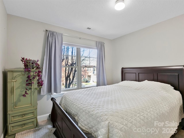 bedroom with carpet and a textured ceiling