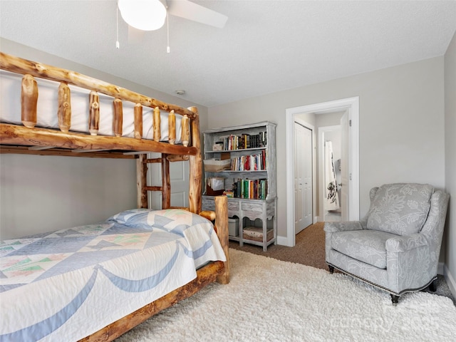 bedroom featuring ceiling fan and carpet