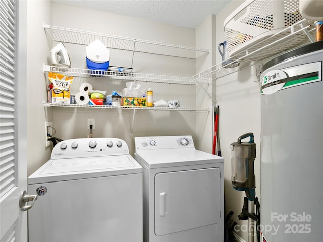 laundry room with gas water heater, a textured ceiling, and washing machine and clothes dryer