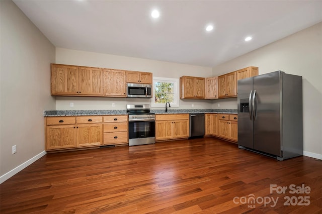 kitchen featuring stainless steel appliances and dark wood-type flooring