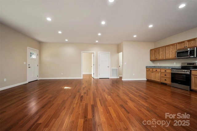 kitchen with dark hardwood / wood-style floors and appliances with stainless steel finishes