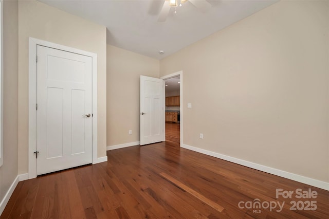 unfurnished bedroom featuring dark hardwood / wood-style floors and ceiling fan