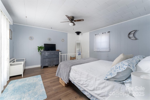 bedroom with ceiling fan, dark hardwood / wood-style flooring, and crown molding