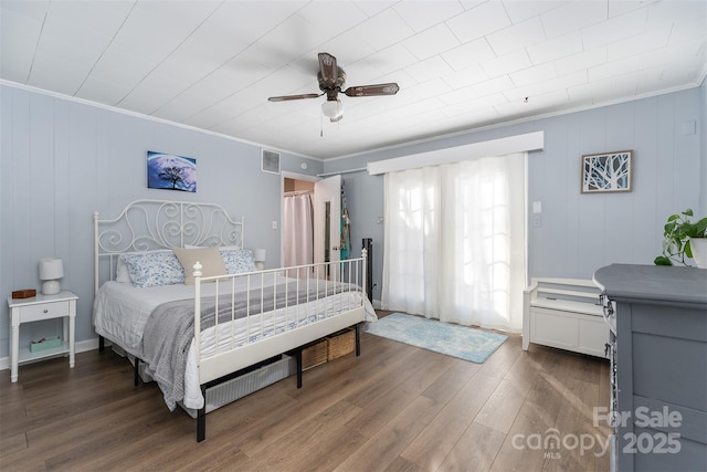 bedroom with ceiling fan, hardwood / wood-style floors, and ornamental molding