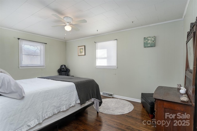 bedroom with dark hardwood / wood-style floors, ceiling fan, and ornamental molding