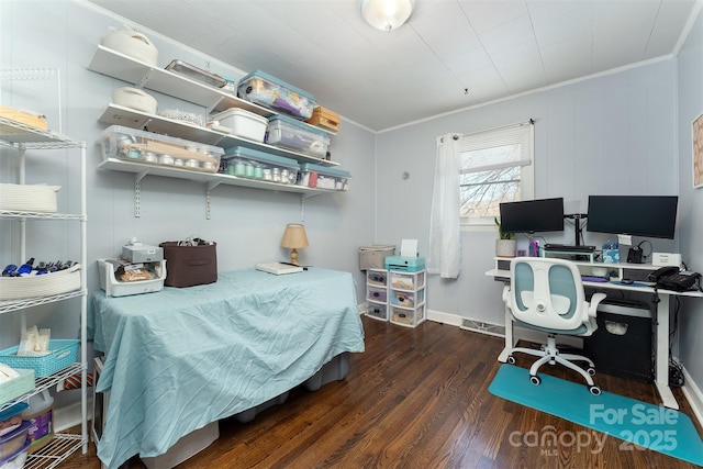 bedroom featuring dark hardwood / wood-style floors and ornamental molding