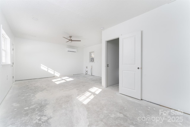 empty room with an AC wall unit and ceiling fan