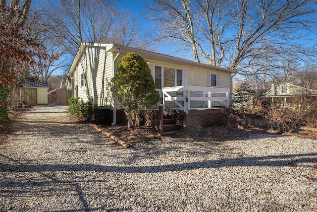 view of front facade with a deck and a storage unit