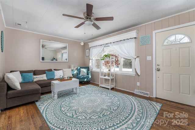 interior space with dark hardwood / wood-style floors, plenty of natural light, and ornamental molding