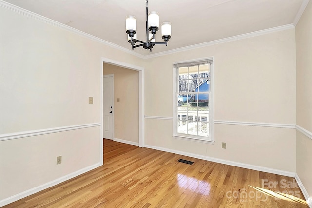 unfurnished dining area with hardwood / wood-style flooring, a chandelier, and ornamental molding