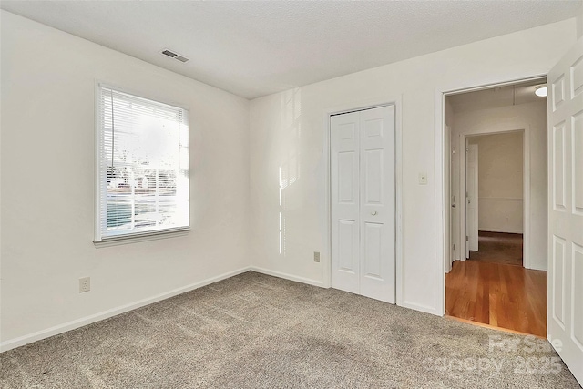 unfurnished bedroom featuring a closet and carpet floors