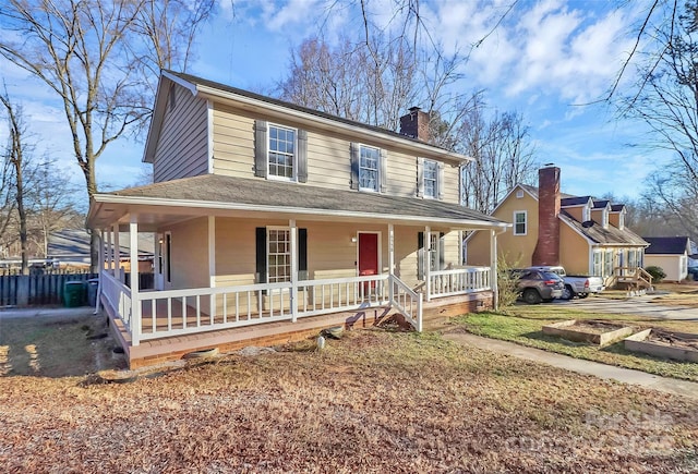 country-style home featuring covered porch