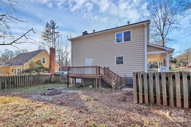 back of house featuring an outdoor fire pit and a wooden deck