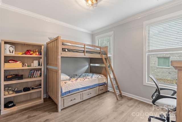 bedroom featuring ornamental molding, light hardwood / wood-style flooring, and multiple windows