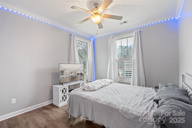 bedroom with ceiling fan, ornamental molding, and dark hardwood / wood-style flooring