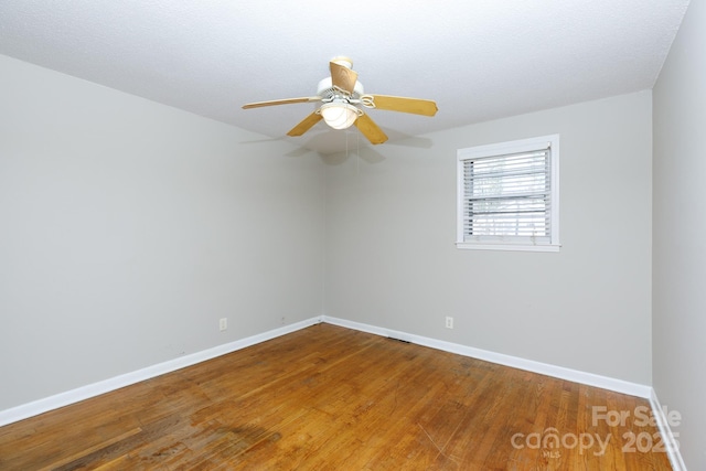 unfurnished room featuring ceiling fan, wood-type flooring, and a textured ceiling