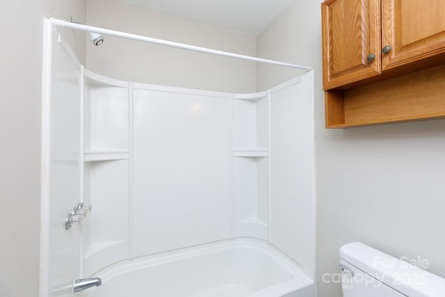 bathroom featuring shower / bathing tub combination and toilet