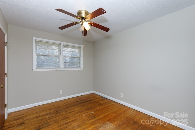 spare room with ceiling fan, hardwood / wood-style floors, and a textured ceiling