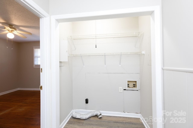 washroom featuring a textured ceiling, ceiling fan, hookup for a washing machine, and dark hardwood / wood-style floors