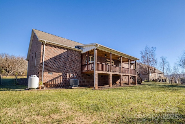 back of property featuring ceiling fan, a yard, a deck, and central AC