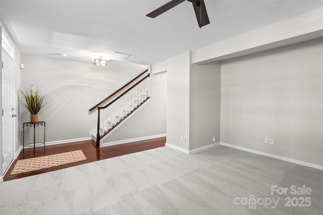 basement featuring carpet flooring and ceiling fan