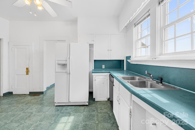 kitchen featuring tile patterned floors, a sink, white cabinetry, white fridge with ice dispenser, and dishwashing machine