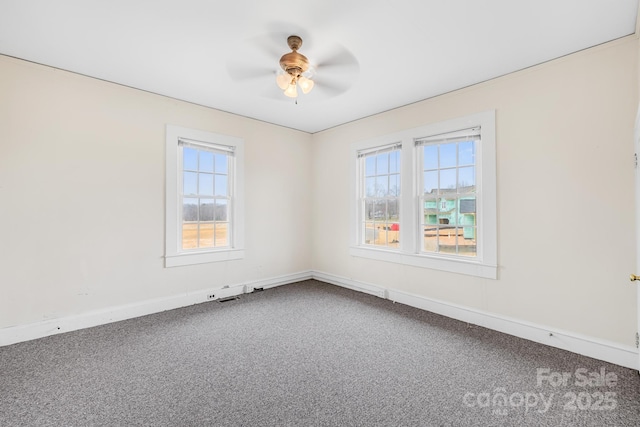 carpeted empty room with visible vents, a ceiling fan, and baseboards