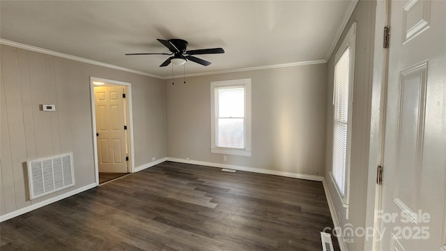 empty room with ceiling fan, dark hardwood / wood-style flooring, and ornamental molding