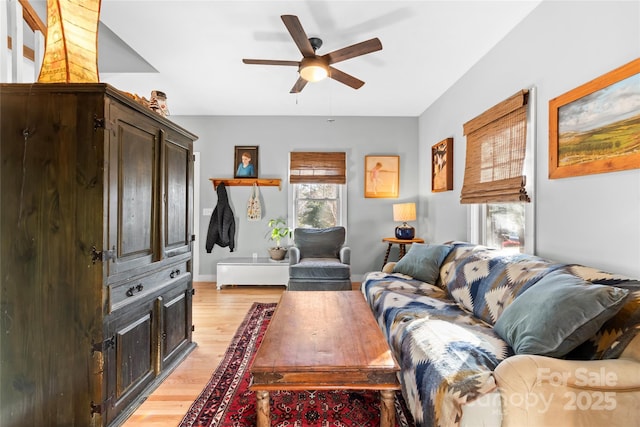 living room with ceiling fan and light wood-type flooring