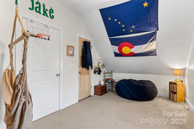 interior space featuring lofted ceiling and carpet floors